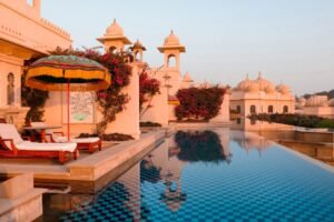 A large swimming pool with a lounge chair next to it