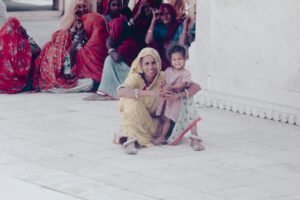 A group of women and children sitting on the ground